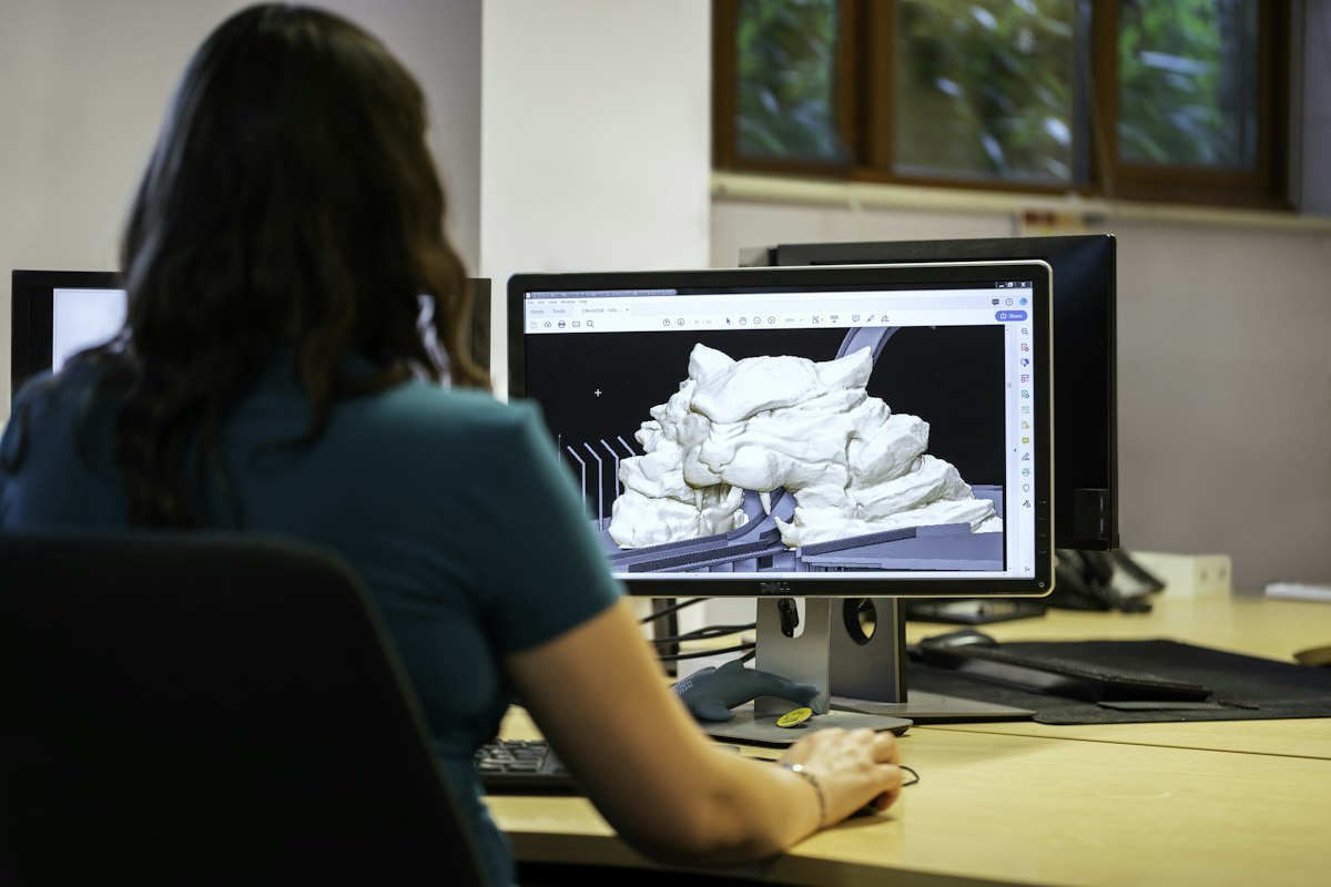 Civil engineer working at a CAD workstation on a theme park attraction design