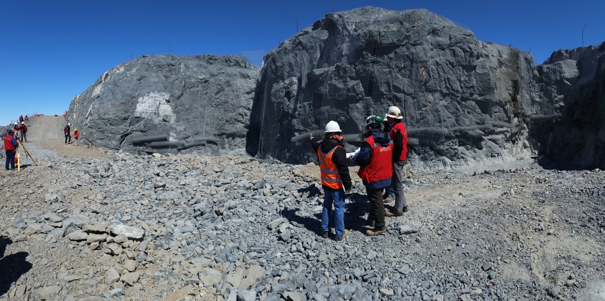 Construction professionals reviewing plans within the excavated Rubin Observatory site