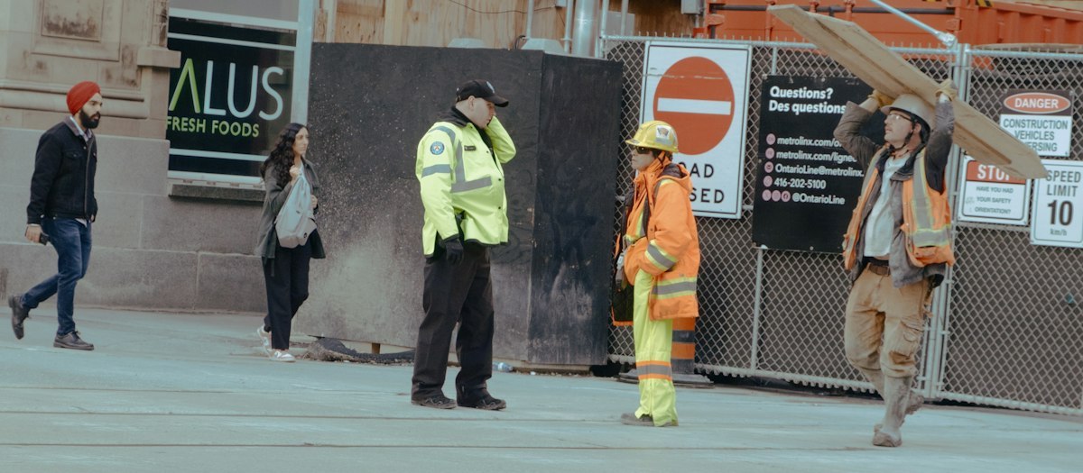 Construction workers wearing high-visibility clothing at an urban work site