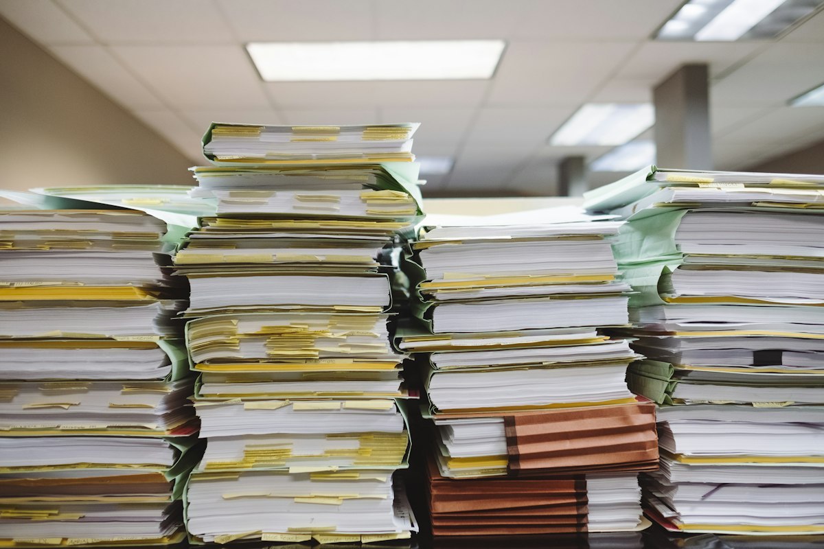 Stacks of paper records and document folders