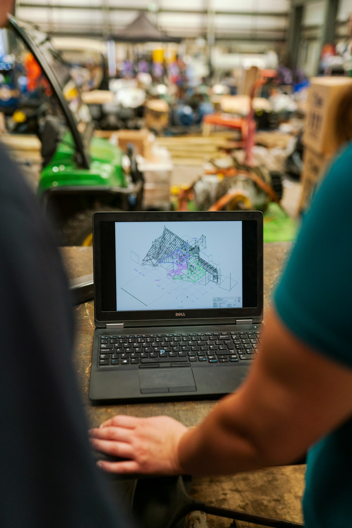 Civil engineers reviewing a 3D structural model on a laptop