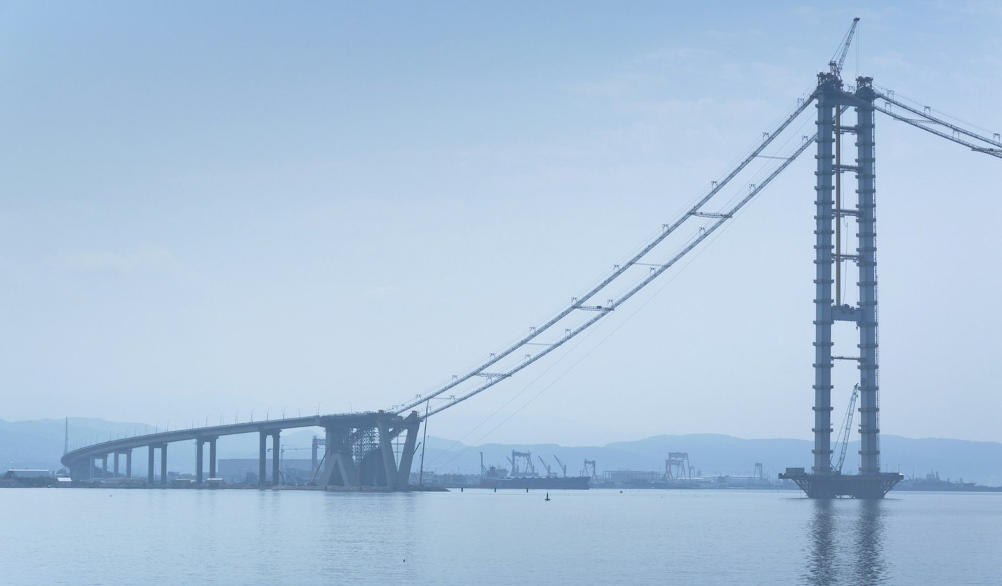 Suspension bridge towers, main cables and incomplete deck during construction of the Osmangazi Bridge in Turkey