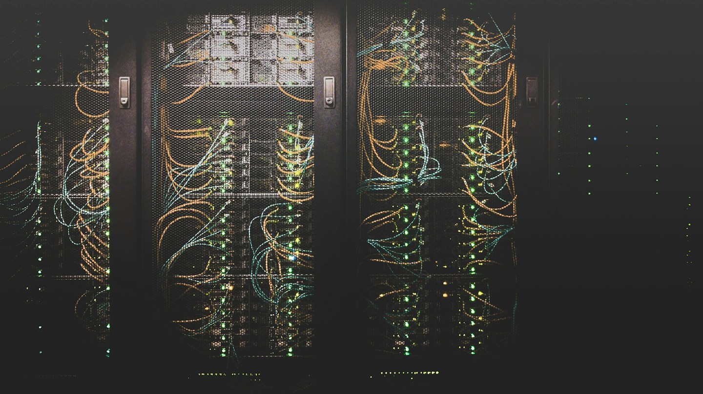 Server cabinets with bundled network cables and rows of indicator lights
